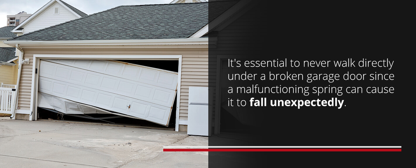 Damaged residential garage door and never walk under a broken garage door.